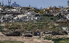 Illustrative: Israeli tanks stationed inside the Gaza Strip, as seen from southern Israel, April 10, 2026. (Tsafrir Abayov/Flash90)