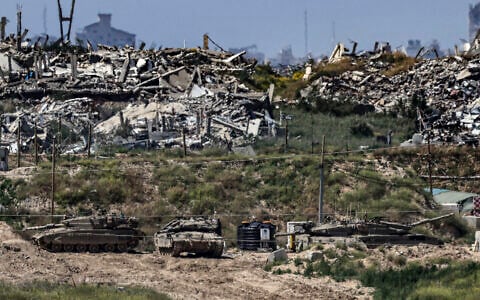Illustrative: Israeli tanks stationed inside the Gaza Strip, as seen from southern Israel, April 10, 2026. (Tsafrir Abayov/Flash90)