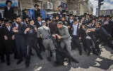 Ultra-Orthodox Jews clash with police during a protest against the draft, in Jerusalem, April 12, 2026. (Chaim Goldberg/Flash90)