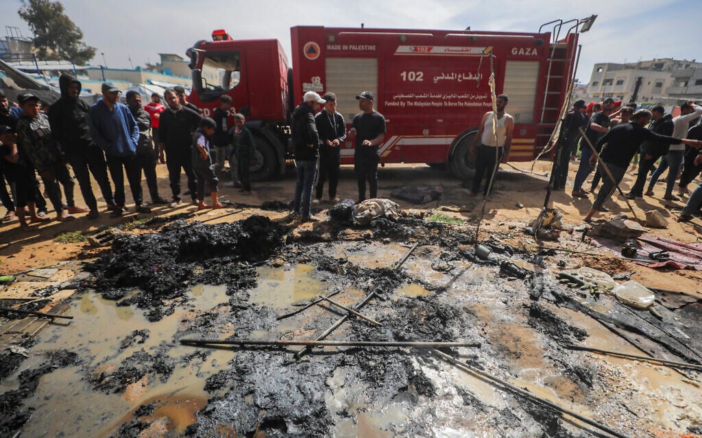 Palestinians at the site of an Israeli airstrike, at the Nuseirat refugee camp in the central Gaza Strip, on April 15, 2026. (Ali Hassan/Flash90)