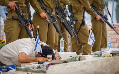 People visit at Ness Ziona Military Cemetery in Jerusalem on Memorial Day, April 21, 2026. (Tal Gal/Flash90)