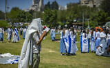 A man wrapped in a prayer shawl prays during Israel’s 78th Independence Day celebrations at Sacher Park in Jerusalem on April 22, 2026. (Yonatan Sindel/Flash90)
