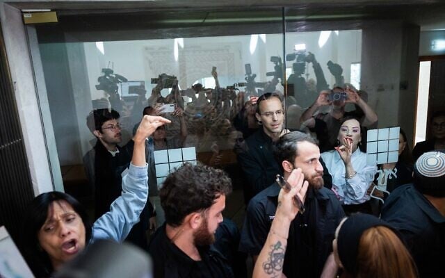 Members of the public opposing a state commission of inquiry into October 7 crowd the door to a hearing at the High Court in Jerusalem, April 23, 2026 (Yonatan Sindel/Flash90) Members of the public opposing a state commission of inquiry into October 7 crowd the door to a hearing at the High Court in Jerusalem, April 23, 2026 (Yonatan Sindel/Flash90)