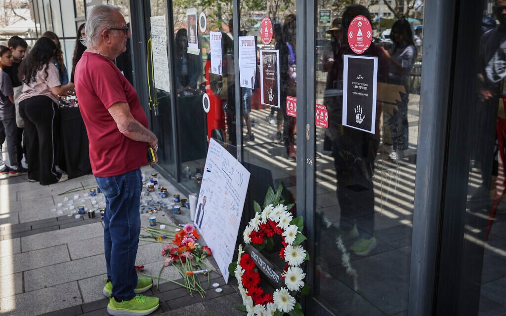 People gather outside a Pizza Hut branch in Petah Tikva where employee Yamenu Binyamin Zelka, was stabbed and killed on Independence Day, April 24, 2026 (Roy Alima/Flash90) People gather outside a Pizza Hut branch in Petah Tikva where employee Yamenu Binyamin Zelka, was stabbed and killed on Independence Day, April 24, 2026 (Roy Alima/Flash90)