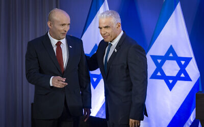 Former prime minister Naftali Bennett (left) and Opposition Leader Yair Lapid speak during a press conference announcing their joint slate named 'Together' ahead of upcoming elections, in Herzliya, April 26, 2026. (Chaim Goldberg/ Flash90)