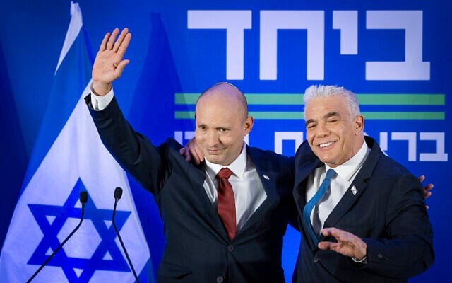 Former prime minister Naftali Bennett, left, and Opposition Leader Yair Lapid announcing their joint run in the coming elections, in Herzliya, central Israel, April 26, 2026. (Chaim Goldberg/Flash90)