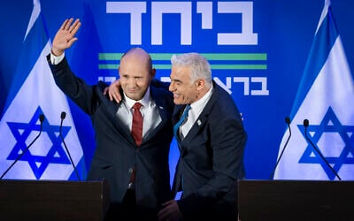 Opposition Leader Yair Lapid, right, and former prime minister Naftali Bennett at a press conference announcing a joint slate named “Together” ahead of upcoming elections in Herzliya, central Israel, April 26, 2026. (Chaim Goldberg/Flash90)