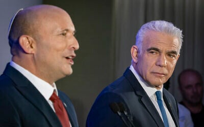 Opposition Leader Yair Lapid (right) and former prime minister Naftali Bennett at a press conference announcing their joint run in the coming elections, in Herzliya, central Israel, April 26, 2026. (Chaim Goldberg/Flash90)
