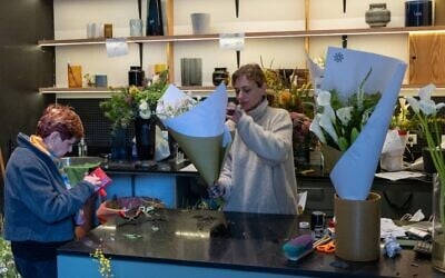 Yael Ben Cnaan helps a customer with a bouquet on the morning before Passover at her store Bishvil Flowers in Tel Aviv, April 1, 2026. (Theia Chatelle via JTA) Yael Ben Cnaan helps a customer with a bouquet on the morning before Passover at her store Bishvil Flowers in Tel Aviv, April 1, 2026. (Theia Chatelle via JTA)