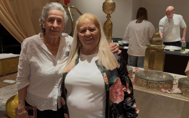 Ruhama Cohen (left) and Simha Shimoni at a Mimouna celebration held at the Leonardo Plaza Hotel in the northern city of Haifa on April 8, 2026. (Sue Surkes/Times of Israel)