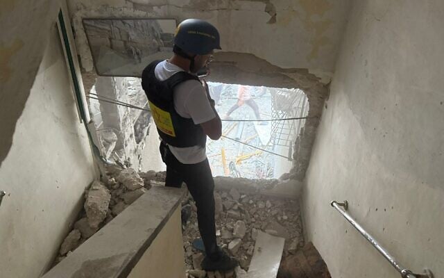 A first responder from the Magen David Adom ambulance service inspects an impact site following an Iranian cluster bomb strike, in Bnei Brak, central Israel, April 1, 2026. (Magen David Adom)