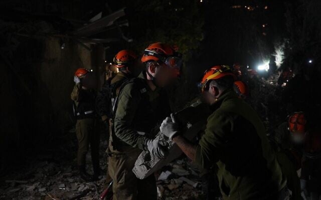 Home Front Command search and rescue forces work amid the rubble of a residential building struck by an Iranian missile in Haifa, April 5, 2026. (Israel Defense Forces)