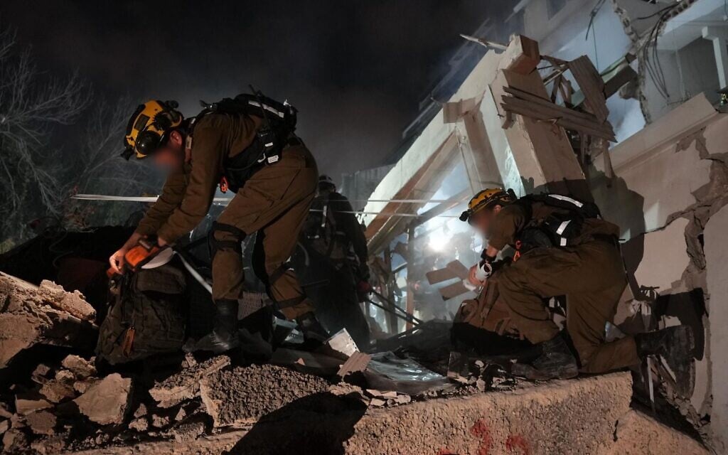 Home Front Command search and rescue forces work amid the rubble of a residential building struck by an Iranian missile in Haifa, April 5, 2026.  (Israel Defense Forces)