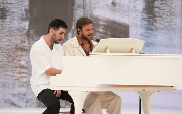 Wounded soldier Dvir Bublil (left) and freed hostage Alon Ohel perform a song together at the President's Residence recorded Independence Day ceremony, April 20, 2026. (Elad Malka)