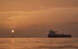 The sun rising behind tankers anchored in the Strait of Hormuz off the coast of Qeshm Island, Iran, April 18, 2026. (Asghar Besharati/AP)