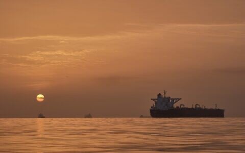 The sun rising behind tankers anchored in the Strait of Hormuz off the coast of Qeshm Island, Iran, April 18, 2026. (Asghar Besharati/AP)
