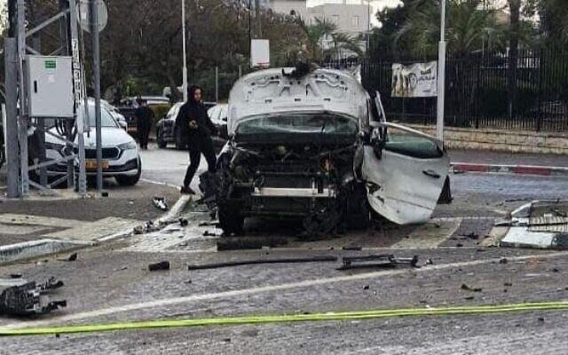 A wrecked car stands idle on the side of the road after it exploded and burst into flames in Tira, a central Arab city, on April 7, 2026. (Fire and Rescue Service)