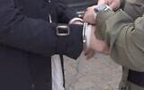 Police arrest a suspect as part of an investigation into alleged identity fraud by a Palestinian couple from the West Bank on April 29, 2026. (Israel Police)