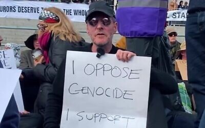 Massive Attack frontman Robert Del Naja holds a sign reading "I oppose genocide, I support Palestine Action" on April 11, 2026, in solidarity with the anti-Israel group, which was proscribed as a terror organization after breaking into defense plants and a Royal Air Force base, causing millions of pounds of damage and assaulting a police officer. (Screenshot via La Jornada on YouTube) Massive Attack frontman Robert Del Naja holds a sign reading "I oppose genocide, I support Palestine Action" on April 11, 2026, in solidarity with the anti-Israel group, which was proscribed as a terror organization after breaking into defense plants and a Royal Air Force base, causing millions of pounds of damage and assaulting a police officer. (Screenshot via La Jornada on YouTube)