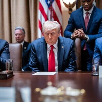 US President Donald Trump prays at the first cabinet meeting of his second term at the White House, in Washington, DC, in February 26, 2025. (Jabin Botsford/The Washington Post via Getty Images/JTA)