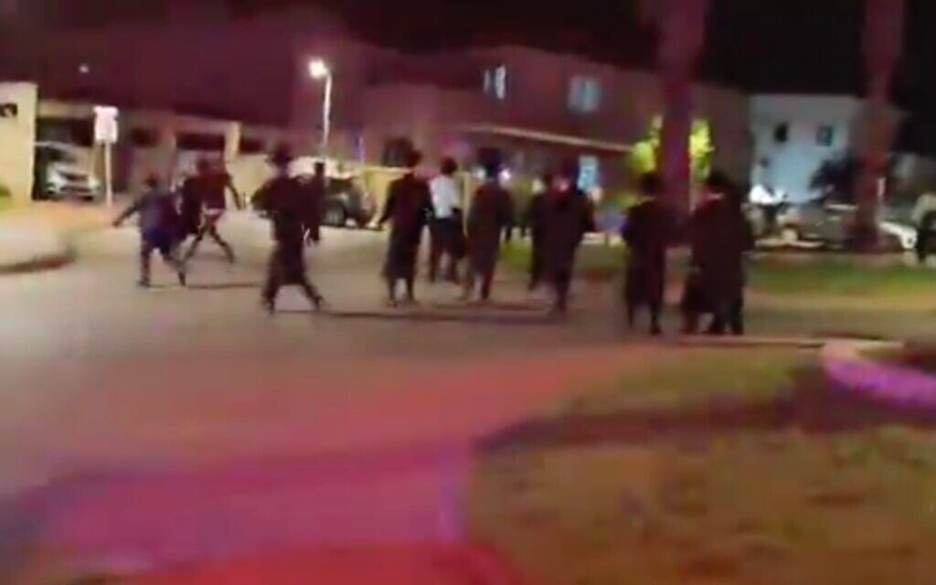 Haredi extremists demonstrate outside the home of the Military Police commander, Brig. Gen. Yuval Yamin, in Ashkelon on May 14, 2026. (X screenshot)