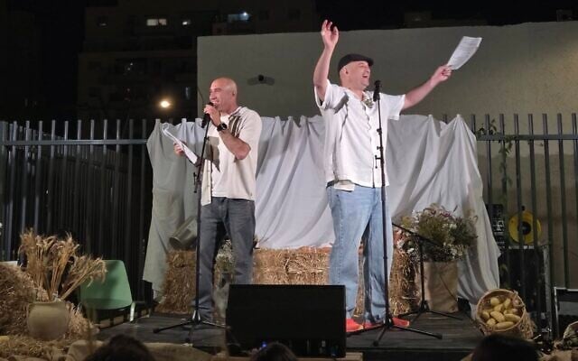 Former hostage Iair Horn, right, at the Kibbutz Nir Oz Shavuot celebration in Carmei Gat on May 21, 2026 (Courtesy)