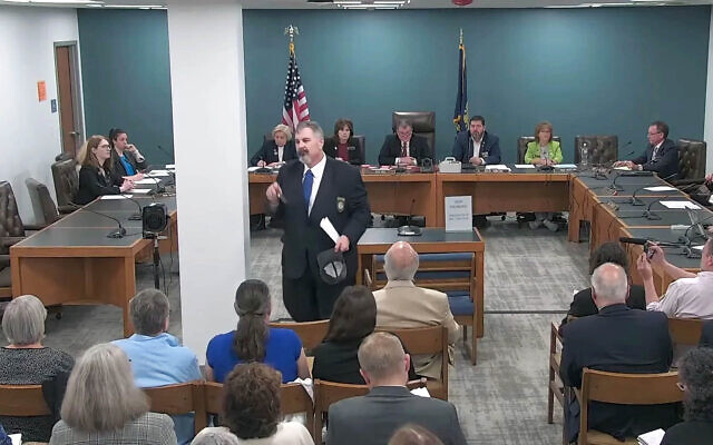 New Hampshire GOP state Rep. Travis Corcoran (center) walks out of his own disciplinary hearing for tweeting a "final solution" reference at a Jewish colleague, April 27, 2026. (Screenshot via JTA) New Hampshire GOP state Rep. Travis Corcoran (center) walks out of his own disciplinary hearing for tweeting a "final solution" reference at a Jewish colleague, April 27, 2026. (Screenshot via JTA)