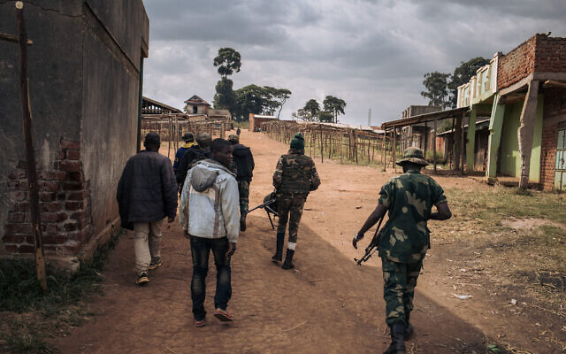 Commanders of the Codeco militia walk through the village of Linga on January 13, 2022, in Ituri province, northeastern Democratic Republic of Congo. (ALEXIS HUGUET / AFP) Commanders of the Codeco militia walk through the village of Linga on January 13, 2022, in Ituri province, northeastern Democratic Republic of Congo. (ALEXIS HUGUET / AFP)