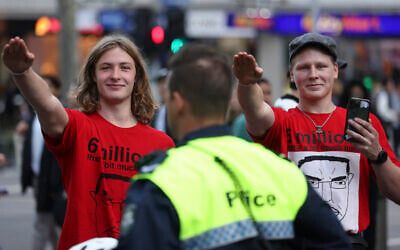 Members of the National Socialist Network perform Nazi salutes during a protest rally in Melbourne on June 4 2023. (Photo by Martin Keep/AFP)