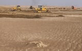 Illustrative: Bulldozers clear sand dunes and extract clay in the desert south of Samawah, Iraq, December 21, 2025. (AHMAD AL-RUBAYE / AFP)