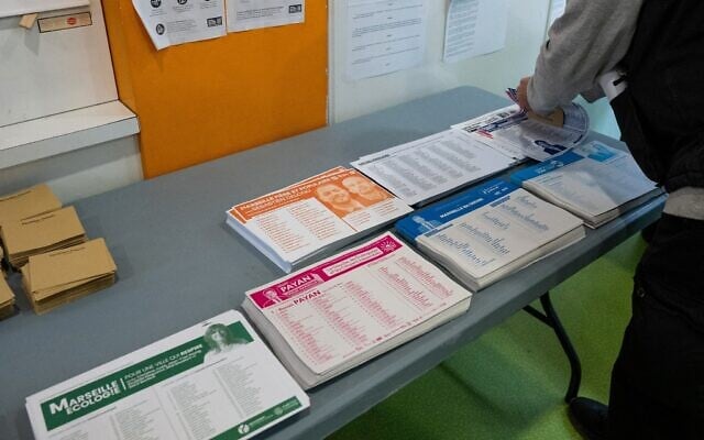 A local resident collects the ballot papers upon arrival at a polling station to cast their ballot during the first round of France's 2026 municipal elections in Marseille, southern France, on March 15, 2026. (Elodie CLEMENT / AFP) A local resident collects the ballot papers upon arrival at a polling station to cast their ballot during the first round of France's 2026 municipal elections in Marseille, southern France, on March 15, 2026. (Elodie CLEMENT / AFP)