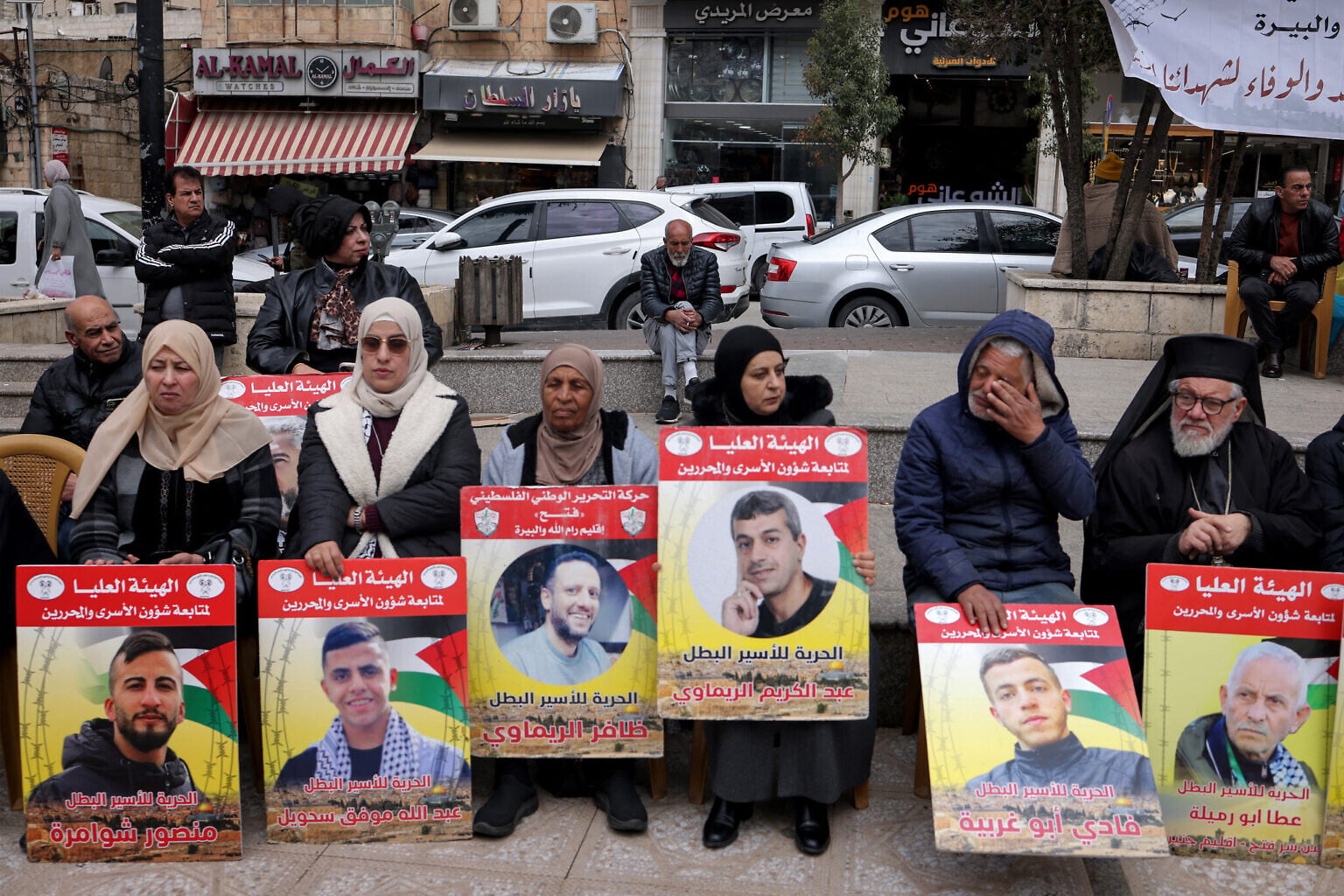 Demonstrators hold placards bearing portraits of Palestinians detained by Israel during a solidarity protest in Ramallah on April 7, 2026. (Zain JAAFAR / AFP)