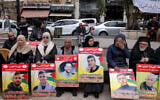 Demonstrators hold placards bearing portraits of Palestinians detained by Israel during a solidarity protest in Ramallah on April 7, 2026. (Zain JAAFAR / AFP)