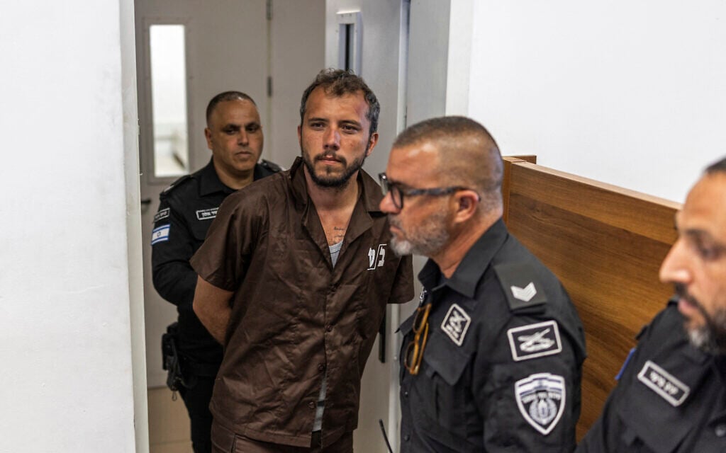 Security personnel escort Brazilian activist Thiago Avila to a court in Ashkelon on May 3, 2026. (Ilia YEFIMOVICH / AFP)