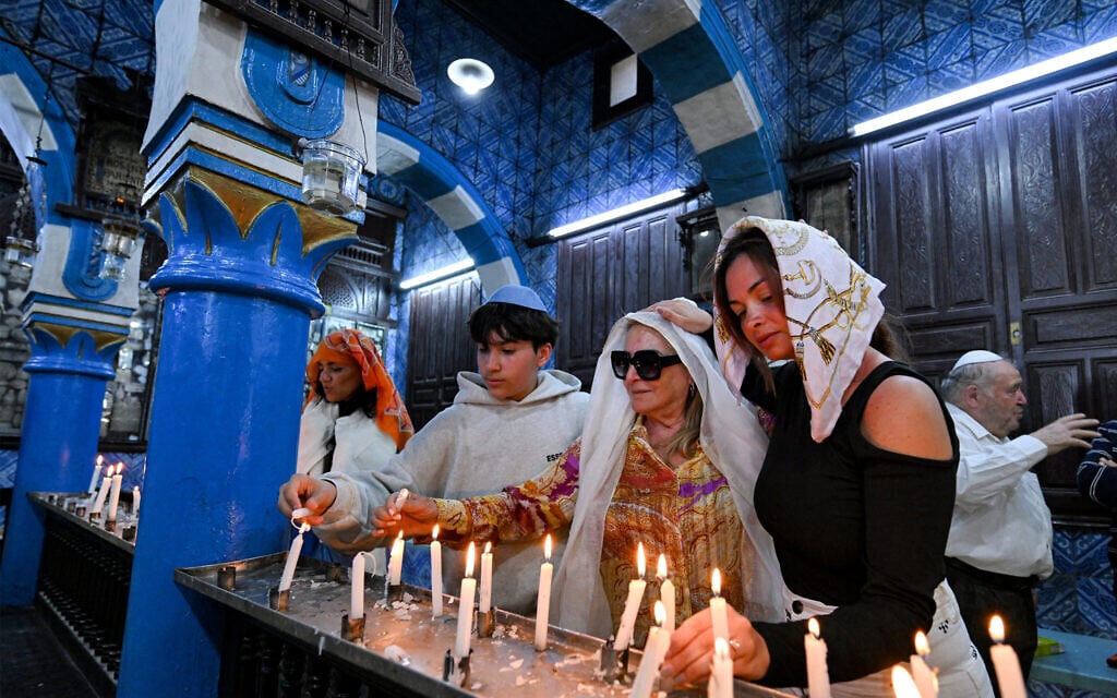 French Jewish pilgrims light candles at the Ghriba synagogue, Africa's oldest synagogue, on Tunisia's southern island of Djerba on May 4, 2026 during the annual pilgrimage to the Jewish holy site. (FETHI BELAID / AFP)