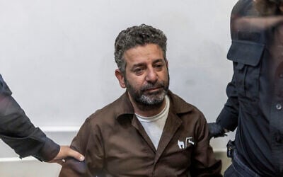 Israeli officers bring Spanish flotilla activist Saif Abu Keshek to a court in Ashkelon on May 5, 2026. (Ilia YEFIMOVICH / AFP)