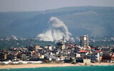 This photograph taken from the southern Lebanese area of Tyre shows smoke rising from the site of an Israeli airstrike that targeted the village of El Qlaile on May 8, 2026. (KAWANT HAJU / AFP)