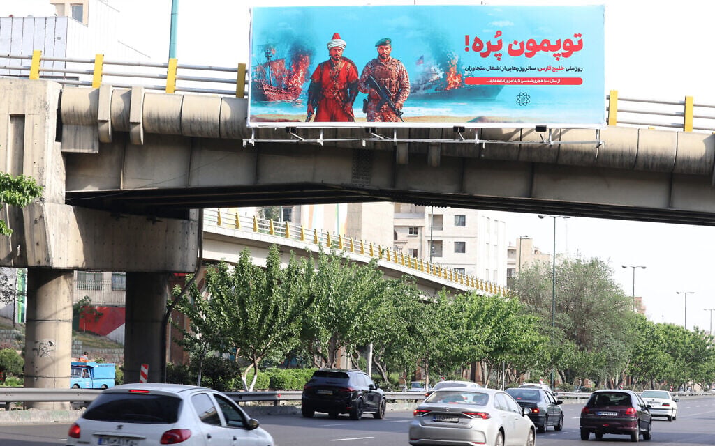 A large anti-American banner that reads in Persian, "Our cannons are full," referring to the Strait of Hormuz, is placed across a bridge that spans the a highway in Tehran on May 12, 2026. (ATTA KENARE / AFP) / A large anti-American banner that reads in Persian, "Our cannons are full," referring to the Strait of Hormuz, is placed across a bridge that spans the a highway in Tehran on May 12, 2026. (ATTA KENARE / AFP) /