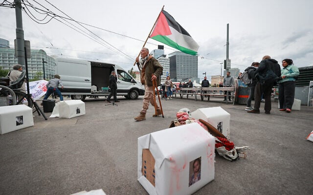 An activist holds a Palestinian flag to protest against the participation of Israel ahead the first semifinal of the Eurovision Song Contest, Vienna, Austria, on May 12, 2026. (Radek MICA / AFP) An activist holds a Palestinian flag to protest against the participation of Israel ahead the first semifinal of the Eurovision Song Contest, Vienna, Austria, on May 12, 2026. (Radek MICA / AFP)
