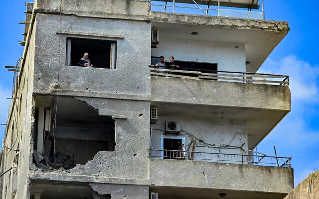 A woman looks on from the window of a damaged building following overnight Israeli strike on Lebanon's southern city of Tyre on May 16, 2026. (Kawnat HAJU / AFP) A woman looks on from the window of a damaged building following overnight Israeli strike on Lebanon's southern city of Tyre on May 16, 2026. (Kawnat HAJU / AFP)