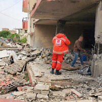 An emergency worker inspects the damage following an Israeli strike on an apartment building in Baalbek, Lebanon, on May 18, 2026. (AFP)