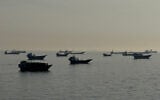Vessels are seen anchored in the Strait of Hormuz, off the port city of Khasab on Oman's northern Musandam Peninsula on May 17, 2026. (AFP)