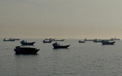 Vessels are seen anchored in the Strait of Hormuz, off the port city of Khasab on Oman's northern Musandam Peninsula on May 17, 2026. (AFP)