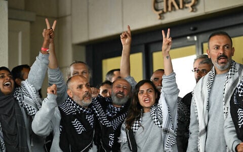 Members of the Global Sumud Flotilla headed for Gaza and arrested and deported by Israel pose outside a terminal following their arrival at Istanbul Airport on May 21, 2026. (Photo by Ozan KOSE / AFP)