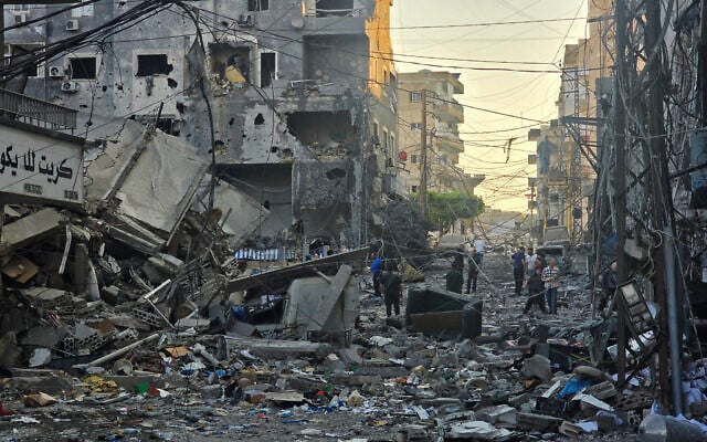 People inspect the site of an Israeli strike in the southern Lebanese coastal city of Tyre on May 23, 2026. (KAWNAT HAJU / AFP) People inspect the site of an Israeli strike in the southern Lebanese coastal city of Tyre on May 23, 2026. (KAWNAT HAJU / AFP)