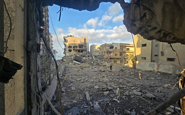 A man looks for his belongings amid debris of a destroyed building at the site of an Israeli strike in the southern Lebanese coastal city of Tyre on May 23, 2026 (KAWNAT HAJU / AFP)