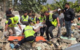 Civil defense members remove a body from the rubble of a residential building hit the previous day by an Israeli strike near the southern town of Burj al-Shamali, on the outskirts of Tyre, on May 27, 2026. (Photo by Kawnat HAJU / AFP)