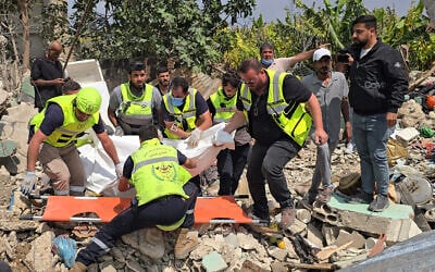 Civil defense members remove a body from the rubble of a residential building hit the previous day by an Israeli strike near the southern town of Burj al-Shamali, on the outskirts of Tyre, on May 27, 2026. (Photo by Kawnat HAJU / AFP)