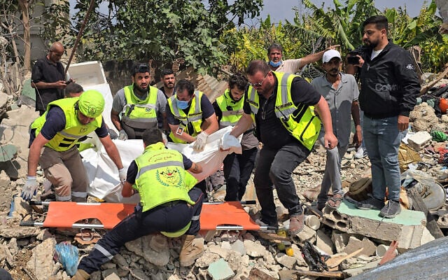 Civil defense members remove a body from the rubble of a residential building hit the previous day by an Israeli strike near the southern town of Burj al-Shamali, on the outskirts of Tyre, on May 27, 2026. (Photo by Kawnat HAJU / AFP) Civil defense members remove a body from the rubble of a residential building hit the previous day by an Israeli strike near the southern town of Burj al-Shamali, on the outskirts of Tyre, on May 27, 2026. (Photo by Kawnat HAJU / AFP)