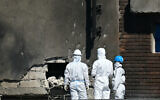 Forensic investigators examine the location of impact after a Russian drone struck an apartment building in Galati, eastern Romania on May 29, 2026, the latest spillover into neighboring states from the four-year war in Ukraine. (Daniel MIHAILESCU / AFP)